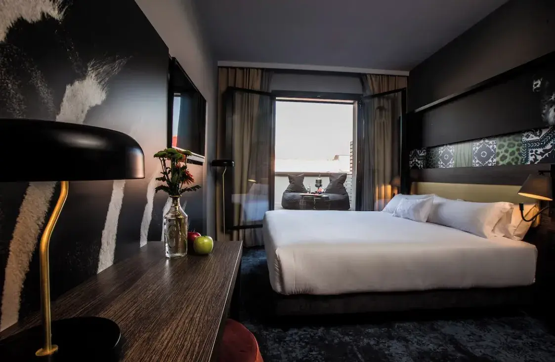 Habitación con cama doble, escritorio y ventana
