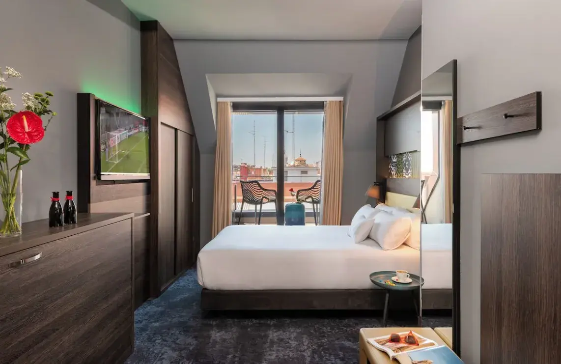 Habitación abuhardillada del Hotel Gran Atlanta con balcón y vistas a los tejados